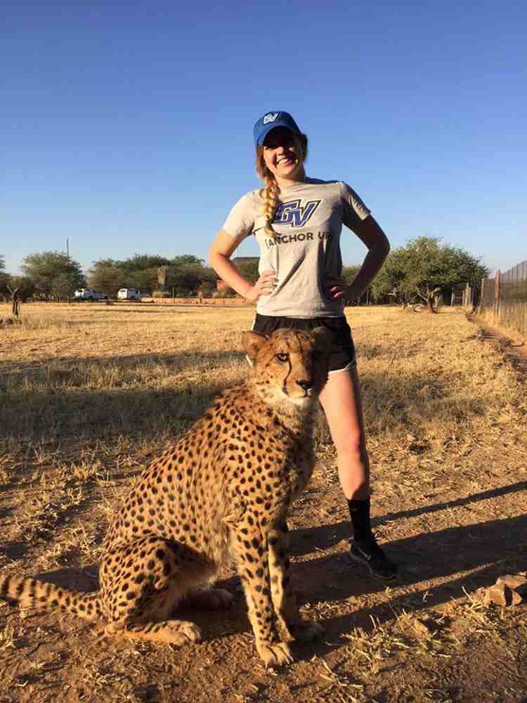 Erin Vargo stands behind the cheetahs at the Cheetah Conservation Fund in Namibia, where she worked as a summer intern.